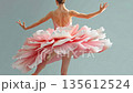 Ballerina performs graceful dance in studio wearing pink tutu with layers in different positions and movements 135612524