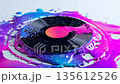 Glossy vinyl record melts into a pool of bright colors on a flat surface during a creative art session 135612526