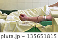 Blood donor participating in plasmapheresis procedure at clinic 135651815
