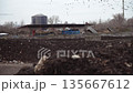 An organic waste treatment plant operating The Industrial Conveyor System Aerator processes organic waste using steam rising inside the waste treatment plant. General plan and scale of organic waste 135667612