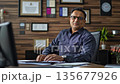 Middle-aged HR manager of Indian descent in a corporate office during a video call 135677926