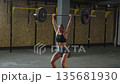 Strong athlete lifts barbell in gym during training session focusing on power and strength Strong athlete lifts barbell in gym during training session focusing on power and strength 135681930