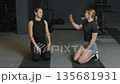 Training session with athletes discussing workout techniques in a gym environment Training session with athletes discussing workout techniques in a gym environment 135681931