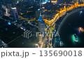 Aerial of illuminated historic buildings and modern skyscrapers along the Huangpu River waterfront 135690018