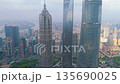 Aerial shot of three modern skyscrapers including Shanghai Tower and Jin Mao Tower above the hazy 135690025