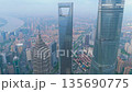 Aerial shot of the Shanghai World Financial Center, Shanghai Tower, and other massive modern 135690775