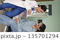 Surgeon showing to patient on tablet further surgical procedure results 135701294