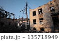 burnt walls, Smoke rising, Crisis zone. Damaged residential buildings with broken glass and rising smoke reveal severe conflict impact. 135718949