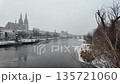 Winter snow over Danube River cathedral and stone bridge in Regensburg Germany slow motion 135721060