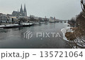 Winter snow falling over Danube River cathedral and stone bridge in Regensburg Germany 135721064