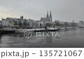 Winter snow falling over Danube River cathedral and stone bridge in Regensburg Germany 135721067