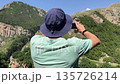 man making picture panorama mountains amateur mobile phone 135726214