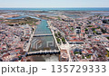 aerial estuary view tavira portugal with visible salterns and tidal channels, nature documentary shot showing marshes, mudflats, wildlife habitat and long coastal approach to sea 135729333