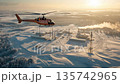 Helicopter flying over industrial site in snowy landscape during sunset 135742965