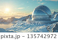Snow-covered observatory on a mountain peak during sunrise with beautiful clouds in the sky 135742972