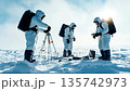 Scientists conduct research in polar region with advanced equipment during a clear day 135742973