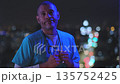 Male doctor working night shift posing with city lights bokeh 135752425