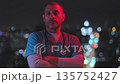 Male nurse posing with ambulance lights at night 135752427