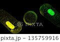 Looping rotating glass translucent capsule 3D Rotating Glass Medical Capsules with Green Outline on Black and White Background - Seamless Loop Animation. 135759916