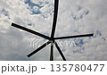 Modern wind turbine blades against cloudy sky 135780477