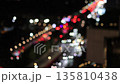 Blurred traffic lights at night with car movement, bokeh effect showing busy road, traffic jam  135810438