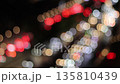 Blurred traffic lights at night with car movement, bokeh effect showing busy road, traffic jam  135810439
