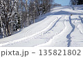 A young girl is tubing down a snow-covered mountain. Winter outdoor recreation 135821802