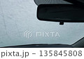 Winter frost significantly reduces driver visibility by covering windshield and obscuring view 135845808