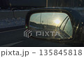 Highway mirror captures glare and motion, Low sun glare reflected in moving highway mirror with flare 135845818