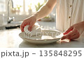 Quiet time spent carefully wiping dishes in a naturally lit kitchen 135848295