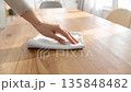 Quietly wiping the table in a room with natural light, it's time to reset your hands. 135848482