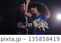 Joyful Engagement Celebration, Bride Exhibits Engagement Ring Amidst Lively Dance, Woman Proudly Reveals Engagement Ring While Dancing Happily With Partner Observing In Studio 135858419