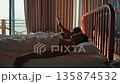 Young couple waking up in a wooden countryside house on a sunny morning. Romantic moment, cozy and 135874532
