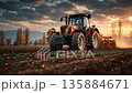 Tractor is plowing a field under the early morning 135884671