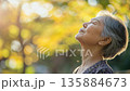 Japanese elderly woman is breathing a fresh air outdoor 135884673