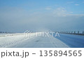 Snow-covered highway 135894565
