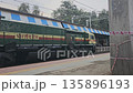 Karjat, India A green Indian Railways diesel locomotive passes through Karjat station, capturing everyday rail movement in a busy suburban junction. 135896193