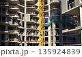 Construction of a building. Construction site with crane. Business, development, industry. 135924839