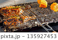 grilled king prawns with smoke, chicken, corn, coals, ash, the back light of the sun 135927453