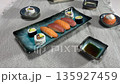 Assorted Sushi Rolls Served on a Plate with Minimal Table Setting 135927459