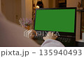 Woman working on green screen laptop in modern home office space 135940493