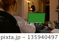 Woman working from home typing on a laptop with green screen 135940497