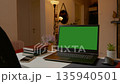 Home office setup with laptop and green screen for creative projects 135940501