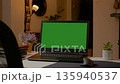 Create a mock up in a stylish home office with a laptop and green screen 135940537