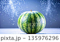 A sunlit watermelon glistens with droplets, camera rising to show curves on a soft blue dotted 135976296
