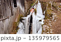 Frozen water mill with frozen water ice at winter in a village 135979565