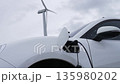 Progressive combination of EV car, charging station and wind turbine. 135980202
