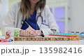 Wooden cubes spell word Hypervitaminosis on clinical table 135982416