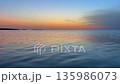 Stunning sunset over the calm waters of Djerba beach in Tunisia creating a tranquil evening 135986073