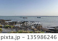 Fishing boats on the serene shores of Djerba, Tunisia under a clear blue sky during a calm day at 135986246